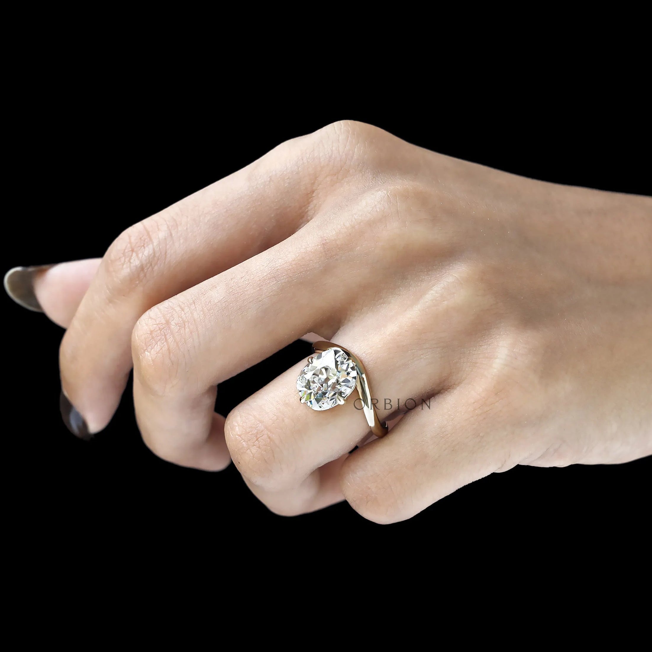 Elongated cushion cut lab diamond ring with curved bypass shank, compass setting, yellow gold