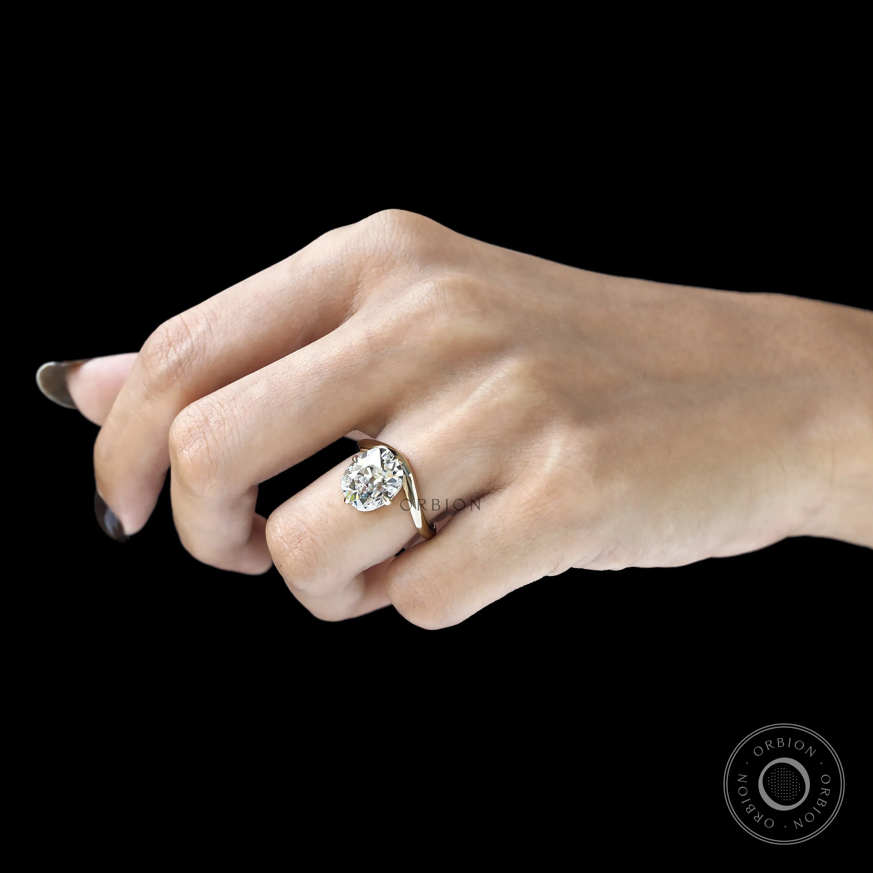 Elongated cushion cut lab diamond ring with curved bypass shank, compass setting, yellow gold