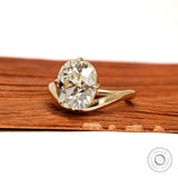 Yellow gold bypass ring featuring curved elongated cushion lab diamond