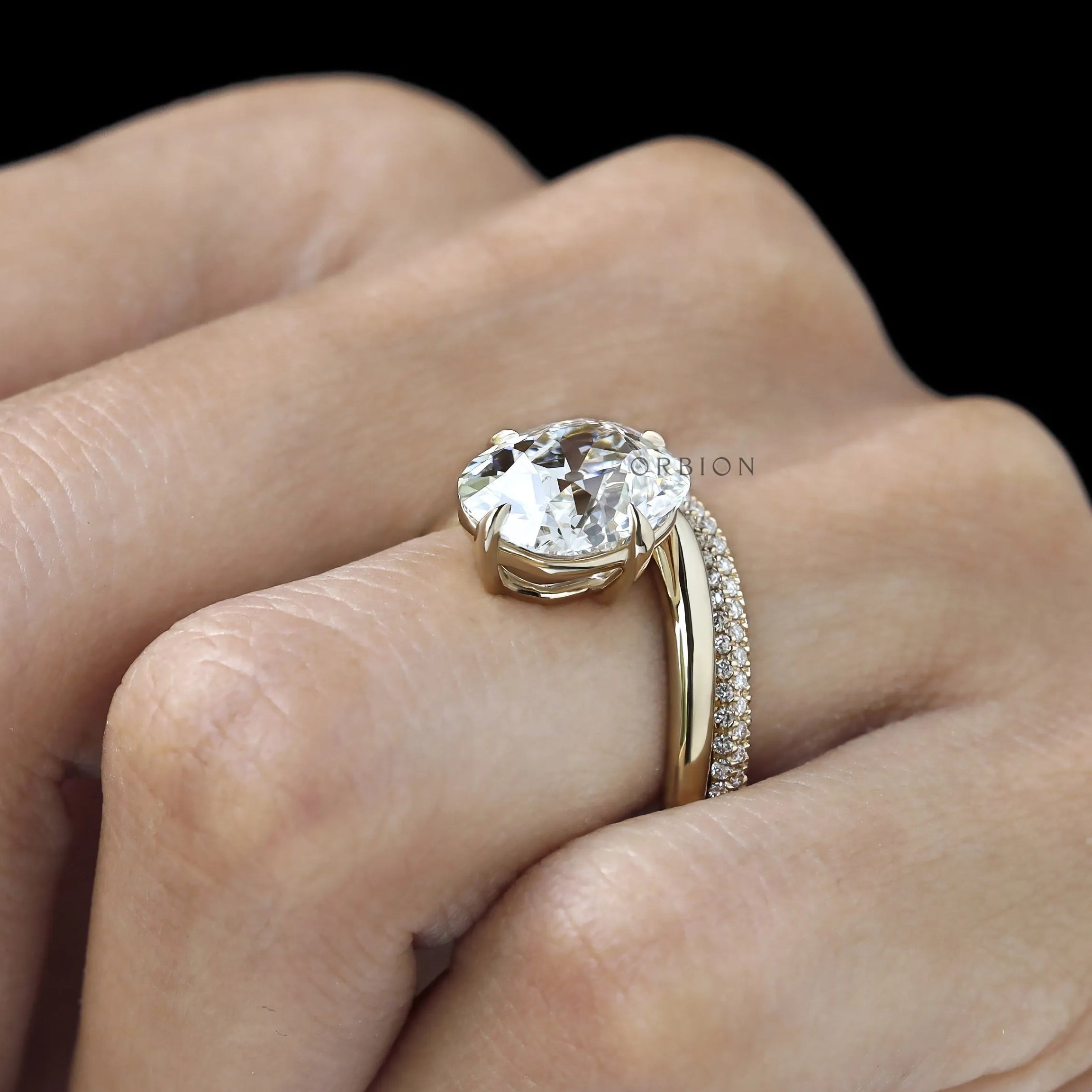 Yellow gold bridal set featuring curved cushion center stone