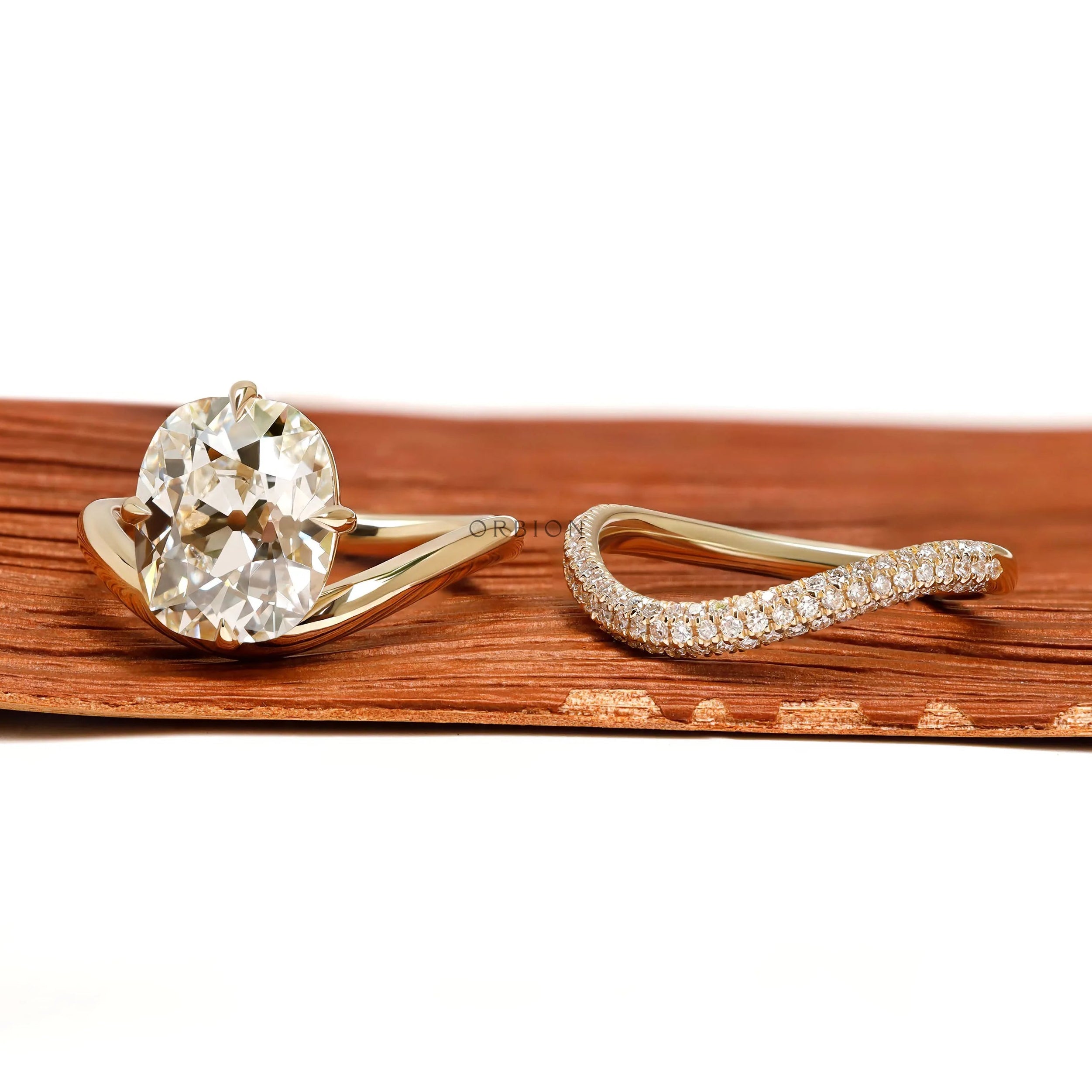 Modern engagement ring set with curved cushion center stone, old mine cut, 14k yellow gold