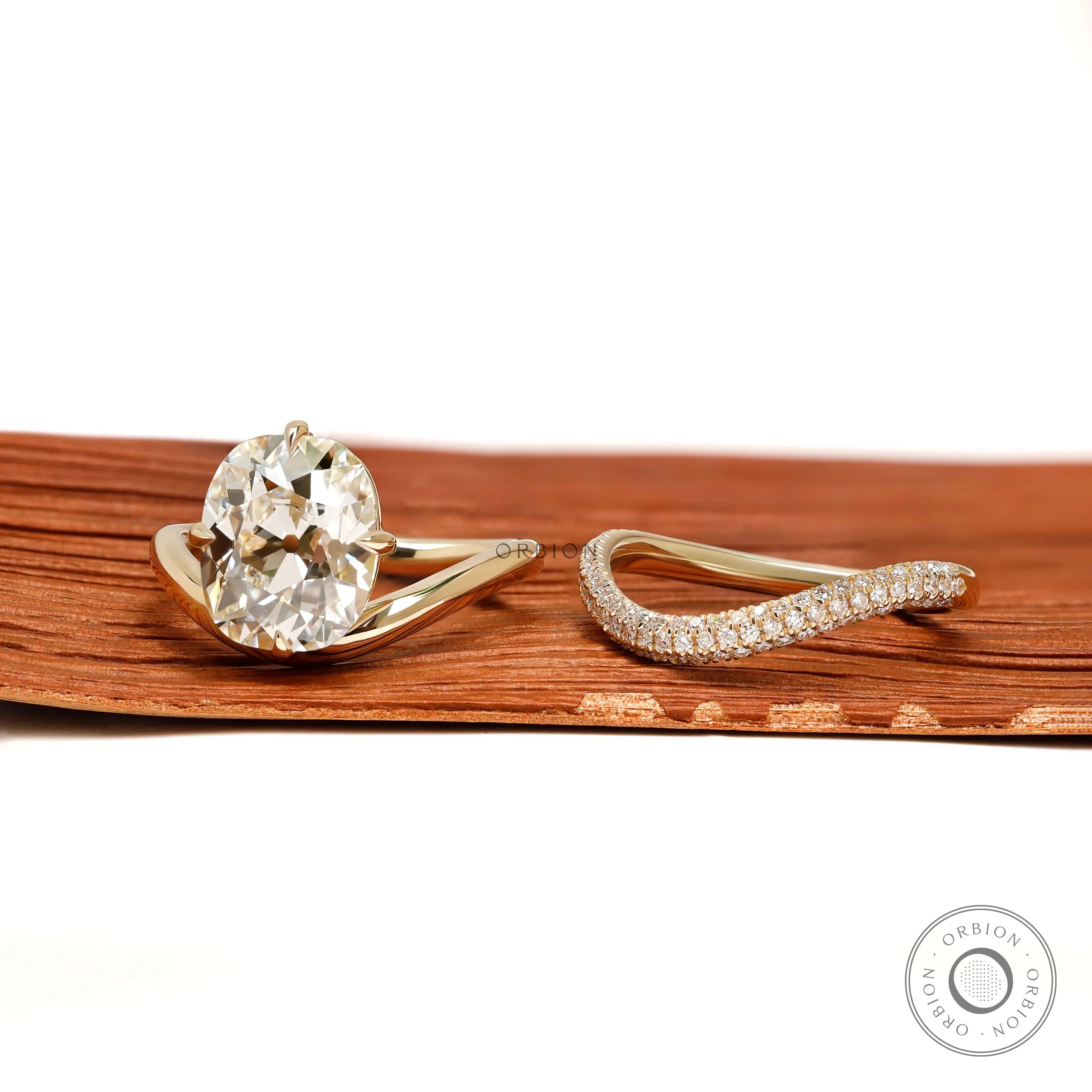 Modern engagement ring set with curved cushion center stone, old mine cut, 14k yellow gold