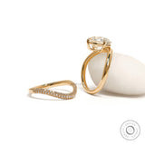 Luxury yellow gold curved bridal set with sparkling cushion-cut center stone and matching band