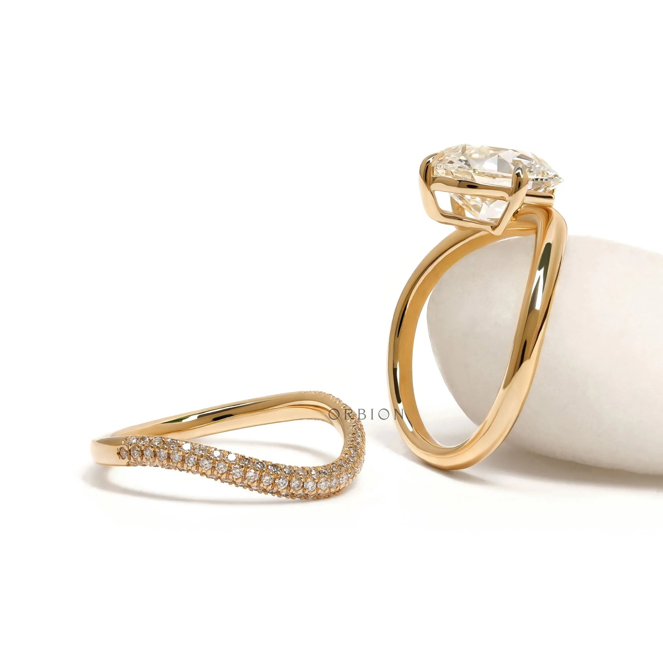 Luxury yellow gold curved bridal set with sparkling cushion-cut center stone and matching band