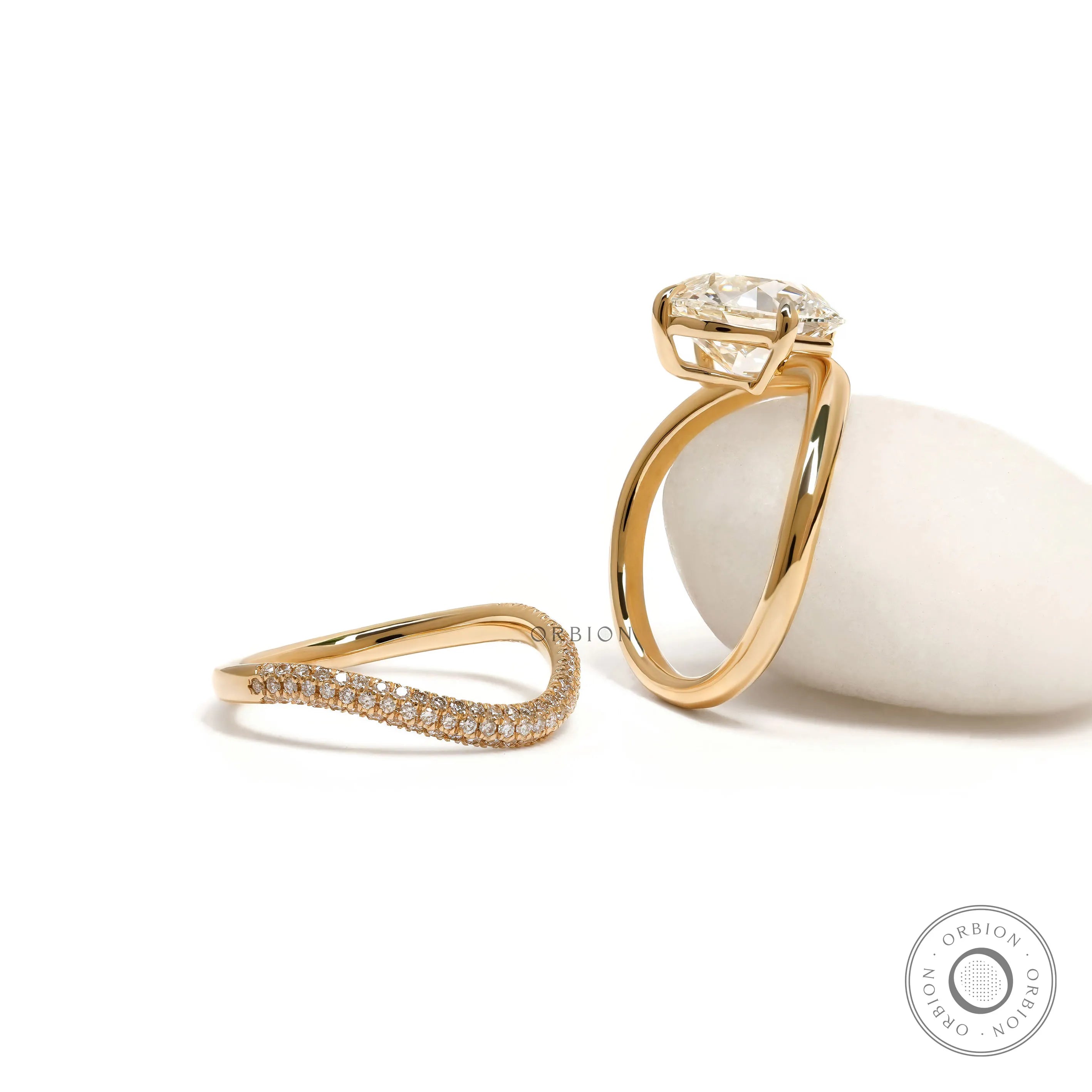 Luxury yellow gold curved bridal set with sparkling cushion-cut center stone and matching band