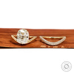 Yellow gold wedding ring set featuring elongated cushion lab diamond with compass setting