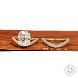 Yellow gold wedding ring set featuring elongated cushion lab diamond with compass setting
