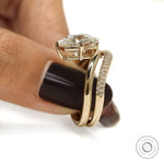 Modern curved engagement ring set in 14k yellow gold, cushion-cut center stone, lab diamond or moissanite