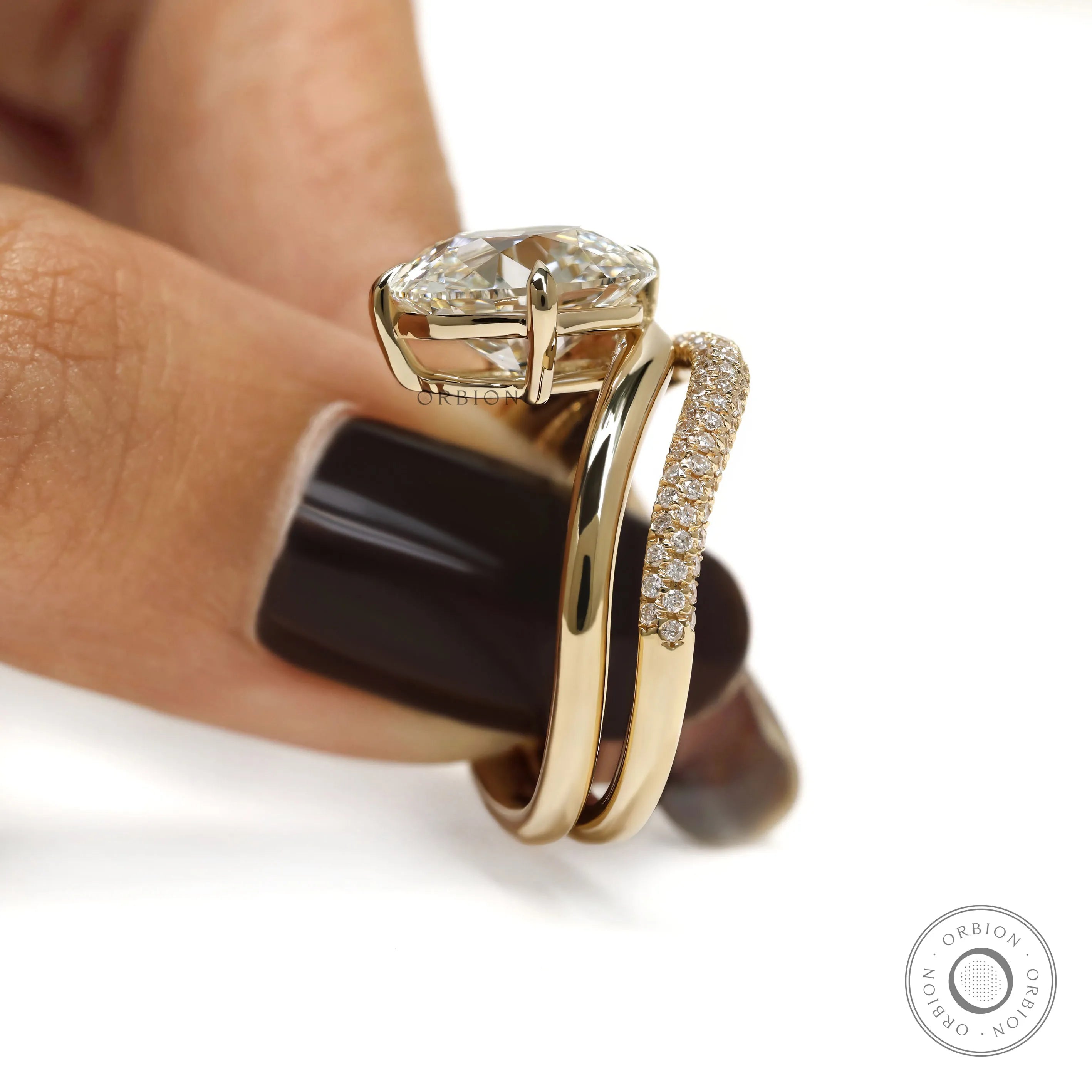 Modern curved engagement ring set in 14k yellow gold, cushion-cut center stone, lab diamond or moissanite