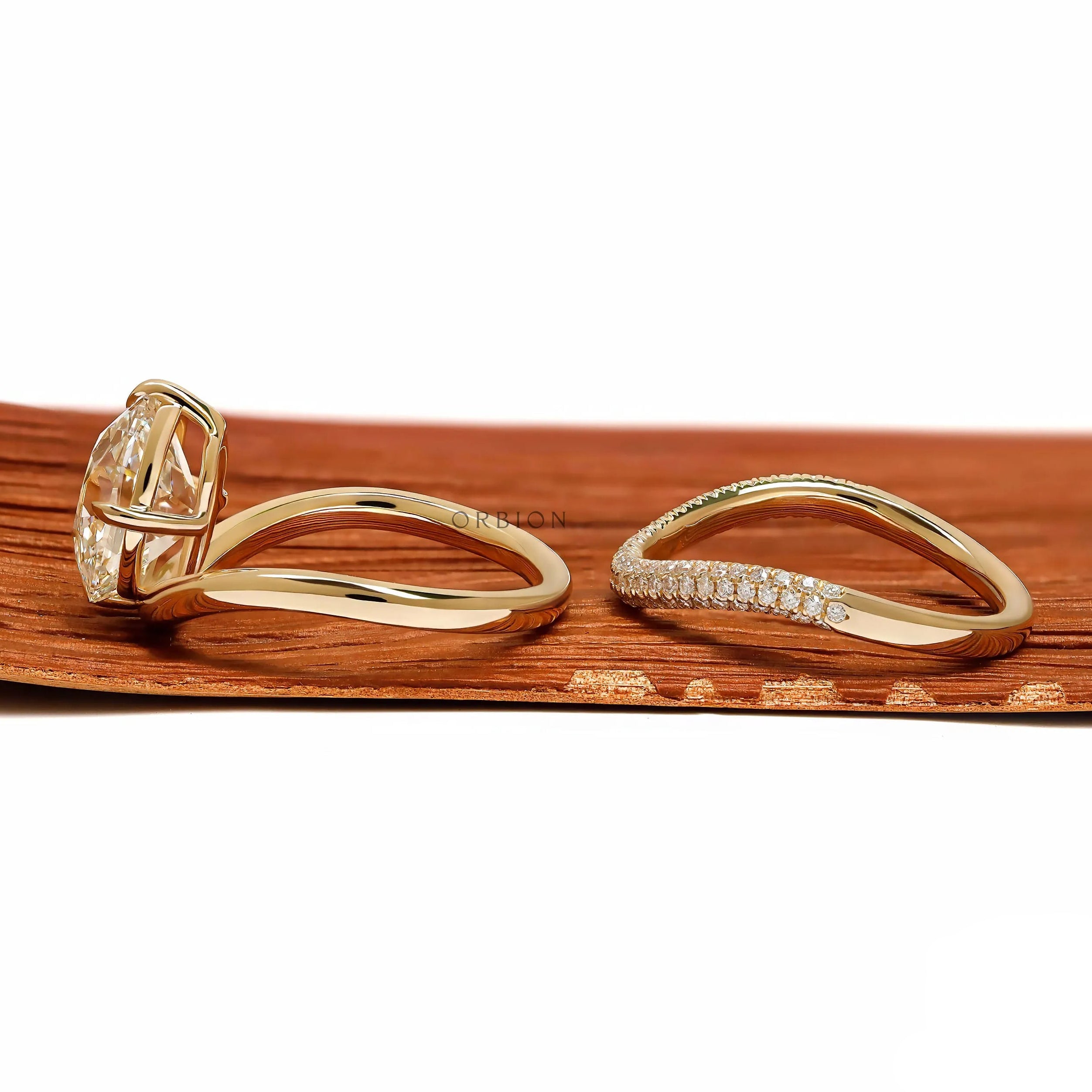Lab diamond or moissanite bridal ring set with compass setting and elongated cushion cut in yellow gold