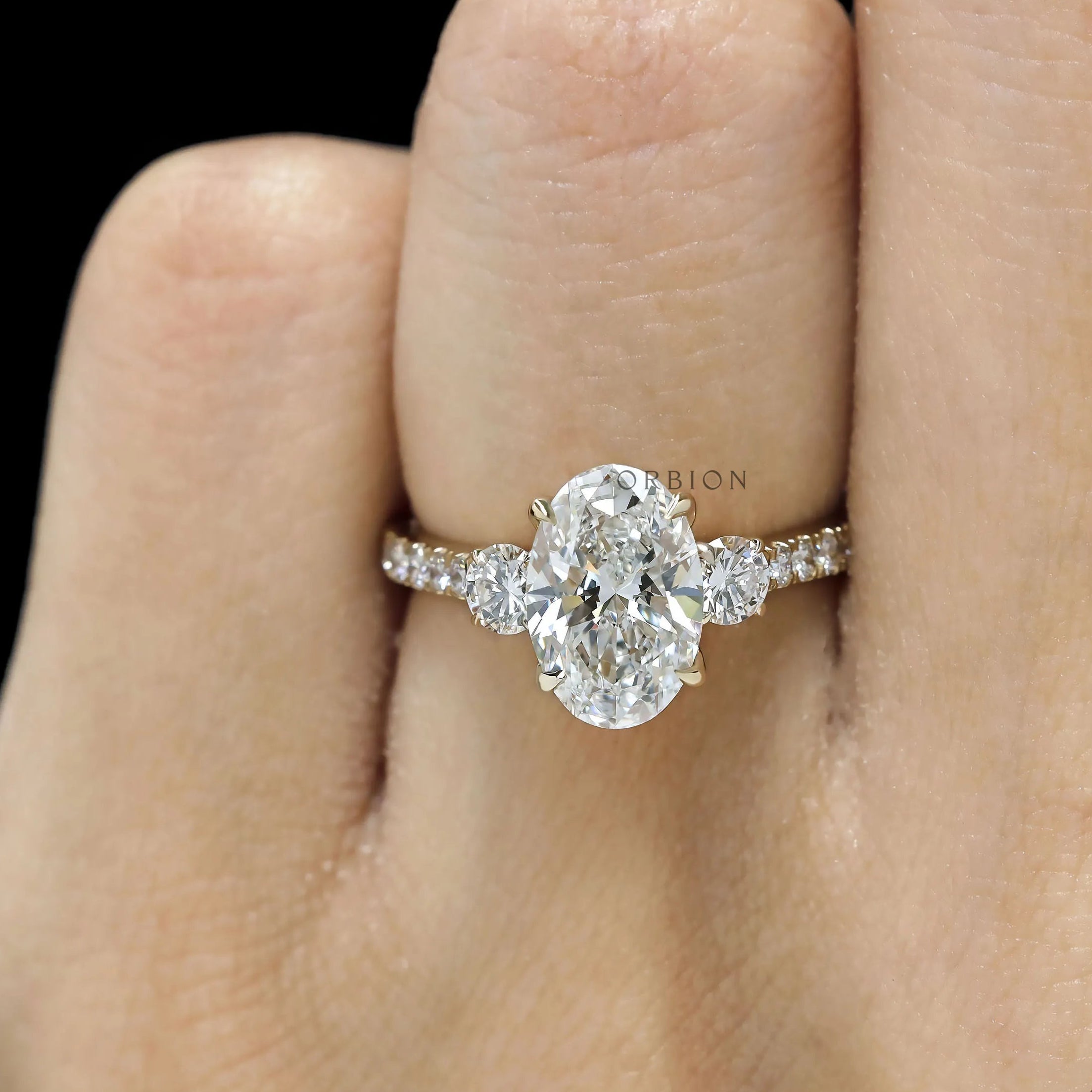 Cathedral style three stone engagement ring with oval lab grown diamond 