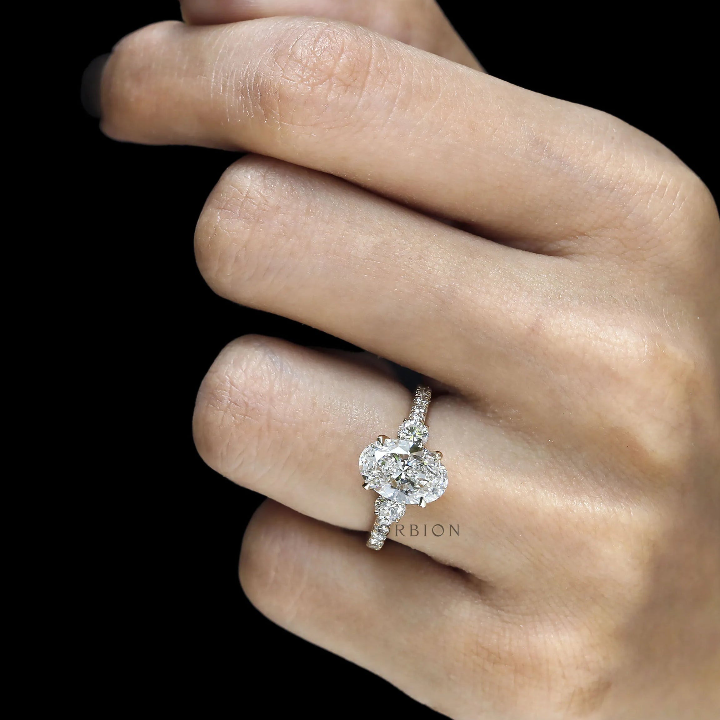 14k yellow gold oval lab grown diamond three stone ring with cathedral setting and pave shank