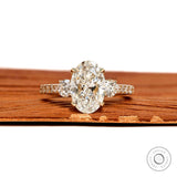 Oval lab grown diamond three stone engagement ring with pave shank in 14k yellow gold, moissanite option