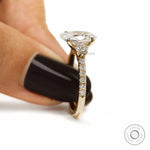 Oval lab grown diamond engagement ring with three stones, pave shank cathedral band in yellow gold