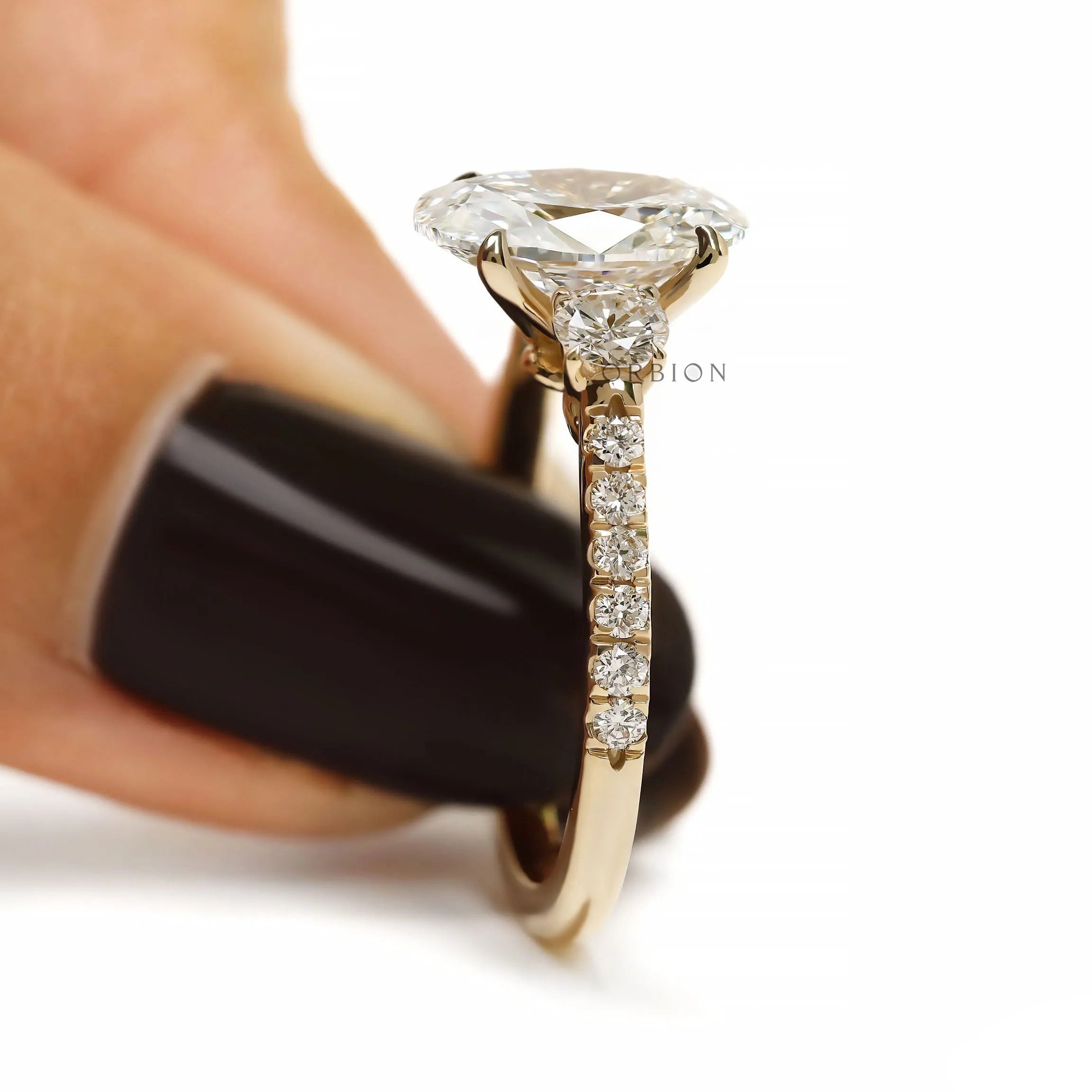 Oval lab grown diamond engagement ring with three stones, pave shank cathedral band in yellow gold
