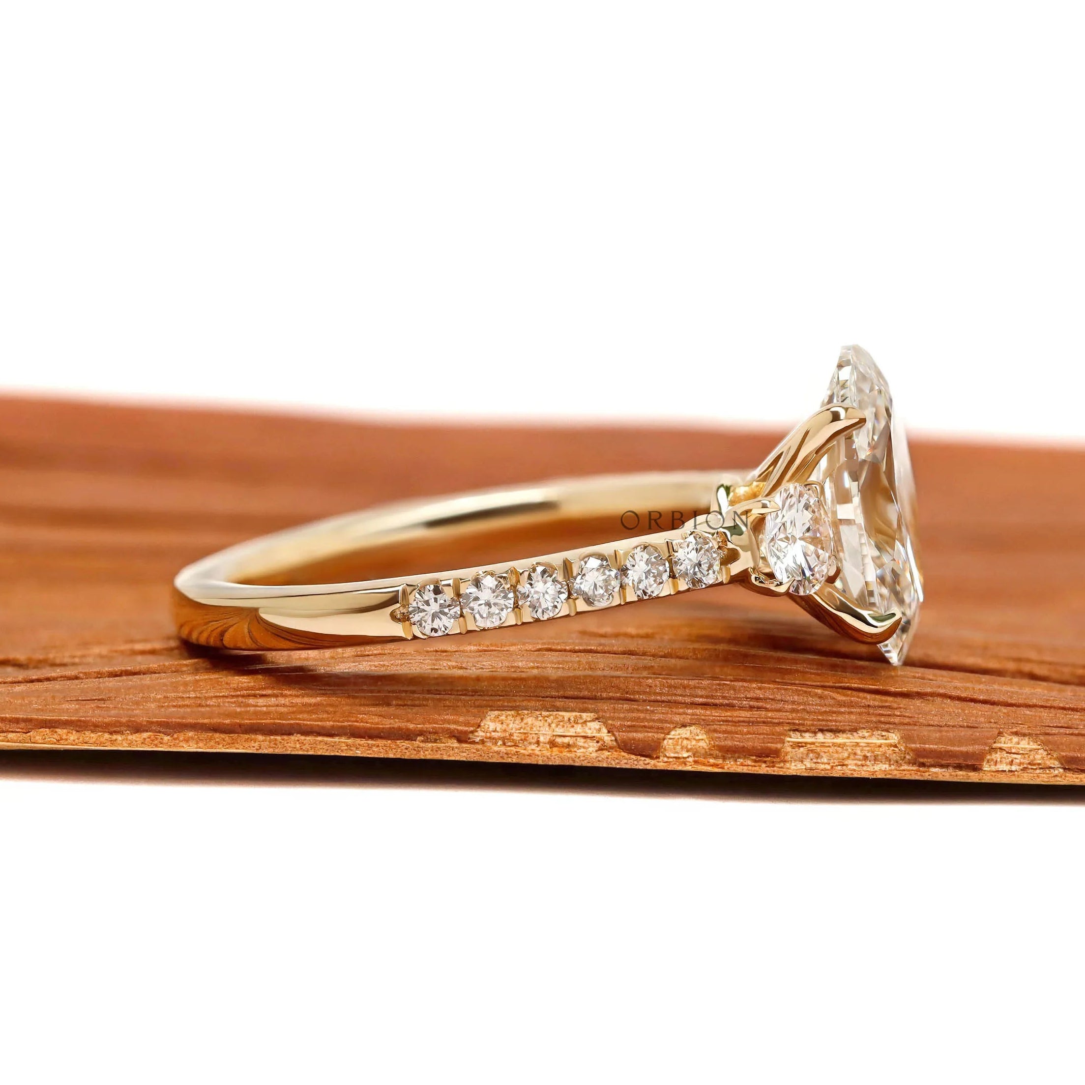 Elegant oval lab grown diamond three stone ring, cathedral band with pave shank, yellow gold
