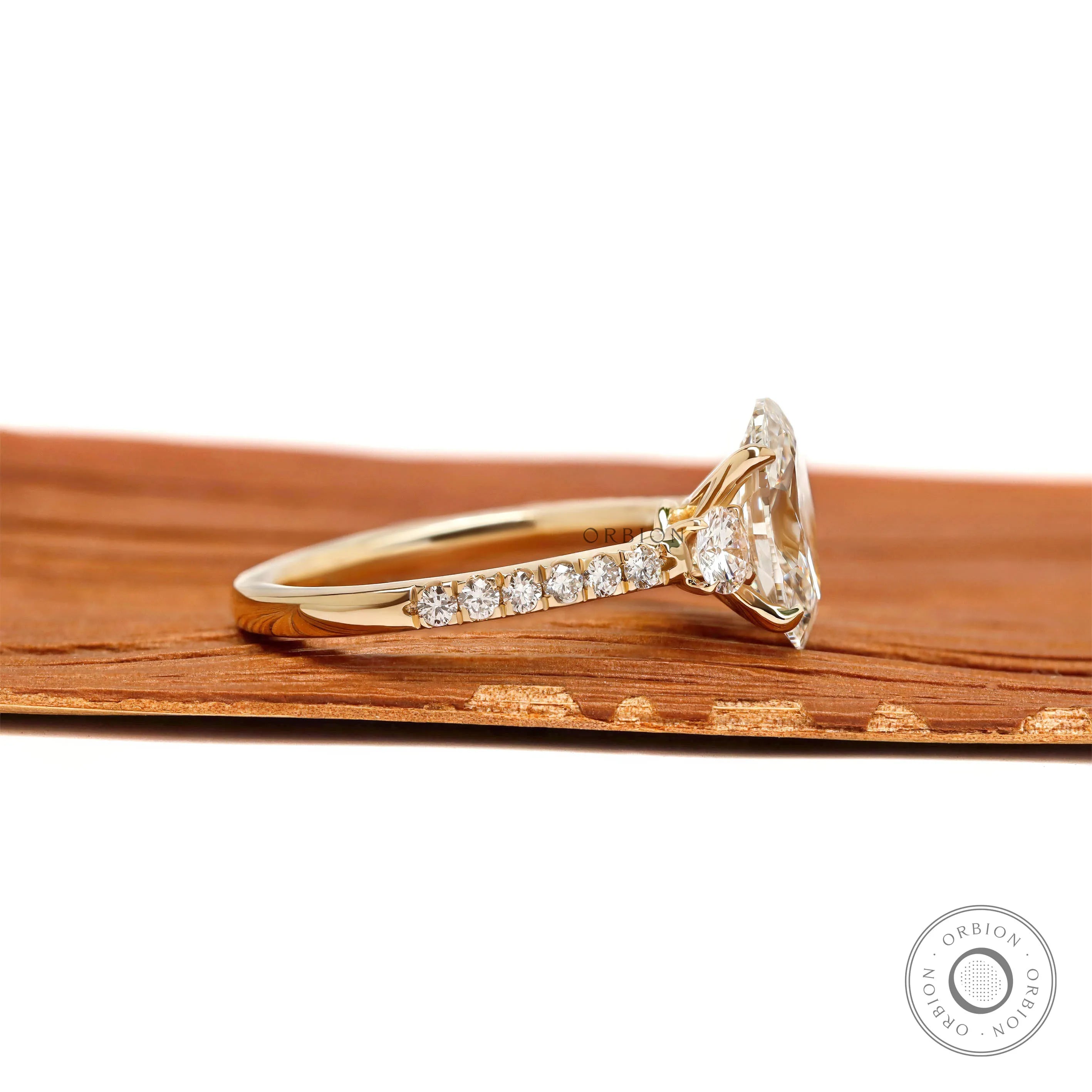 Elegant oval lab grown diamond three stone ring, cathedral band with pave shank, yellow gold