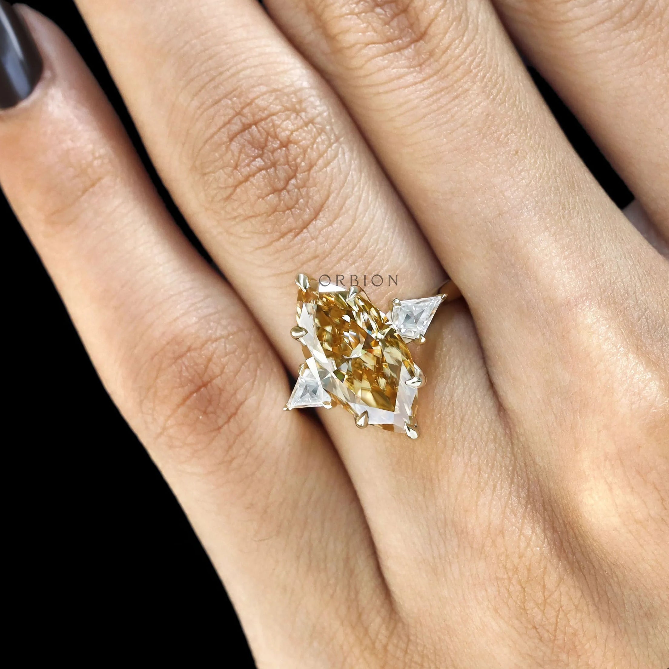 Marquise champagne moissanite engagement ring with tulip set, kite accents and three stones in 10k yellow gold