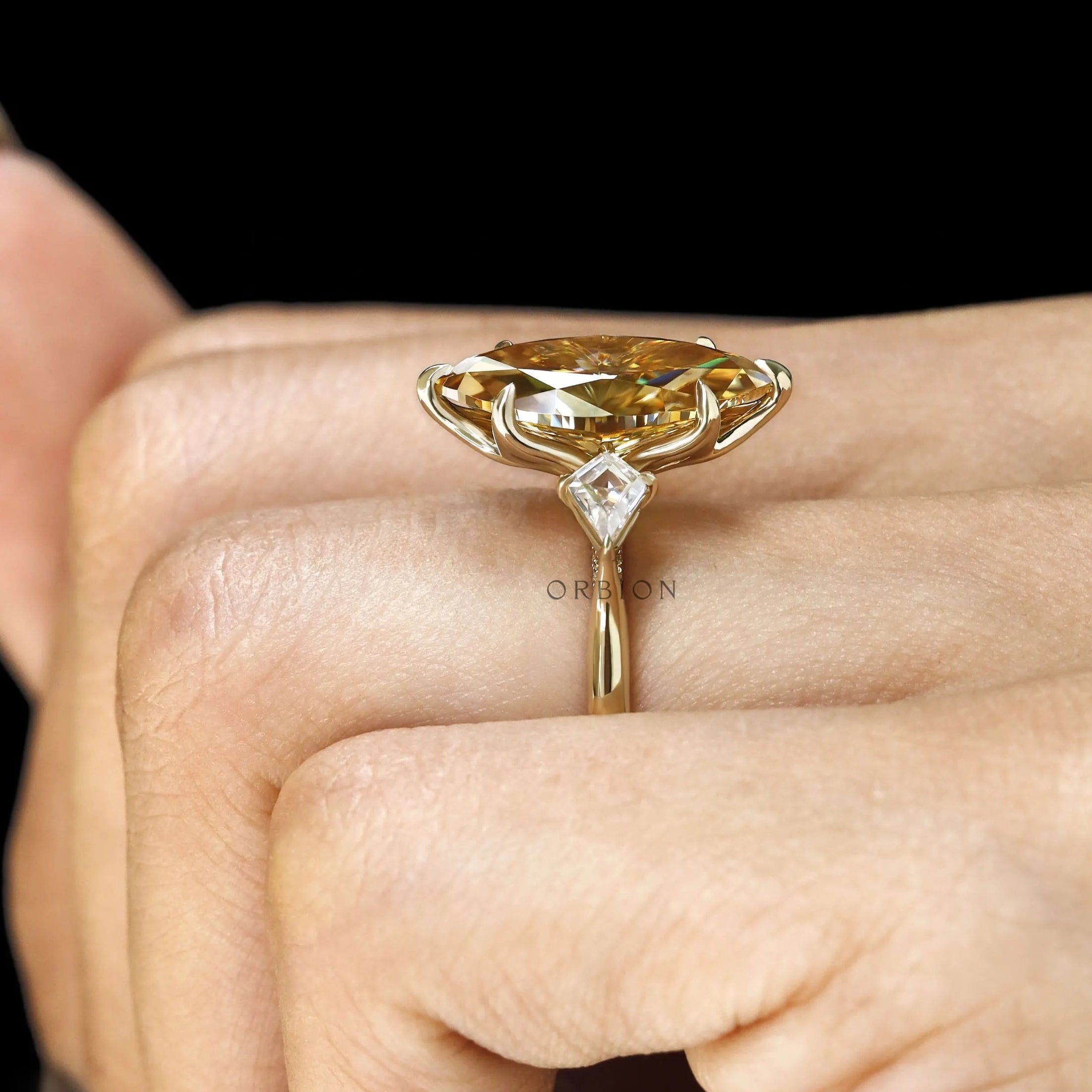 Elegant marquise three stone moissanite ring with champagne center, tulip setting, and yellow gold band