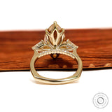10k yellow gold marquise champagne moissanite ring with three stones, tulip set, accented bridge