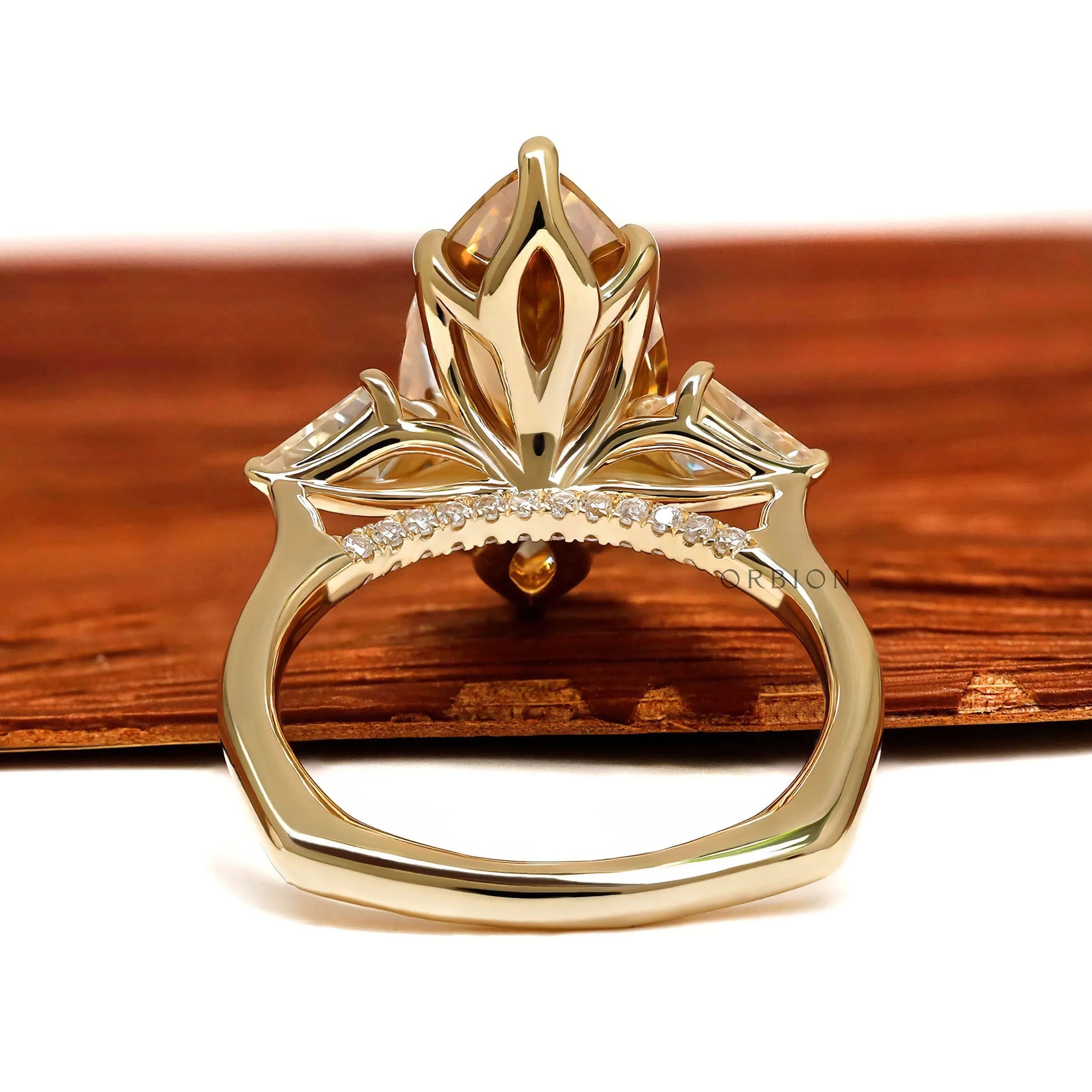 10k yellow gold marquise champagne moissanite ring with three stones, tulip set, accented bridge