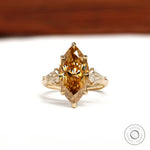 Marquise champagne three stone moissanite ring with tulip setting and kite side stones in 10k yellow gold