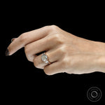 Art deco three stone ring featuring an elongated asscher center stone and baguette details