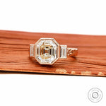 Art Deco elongated Asscher three stone engagement ring with baguette accents in 18k rose gold