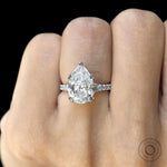 Handmade pear cut bridal ring in white gold with sparkling side stones