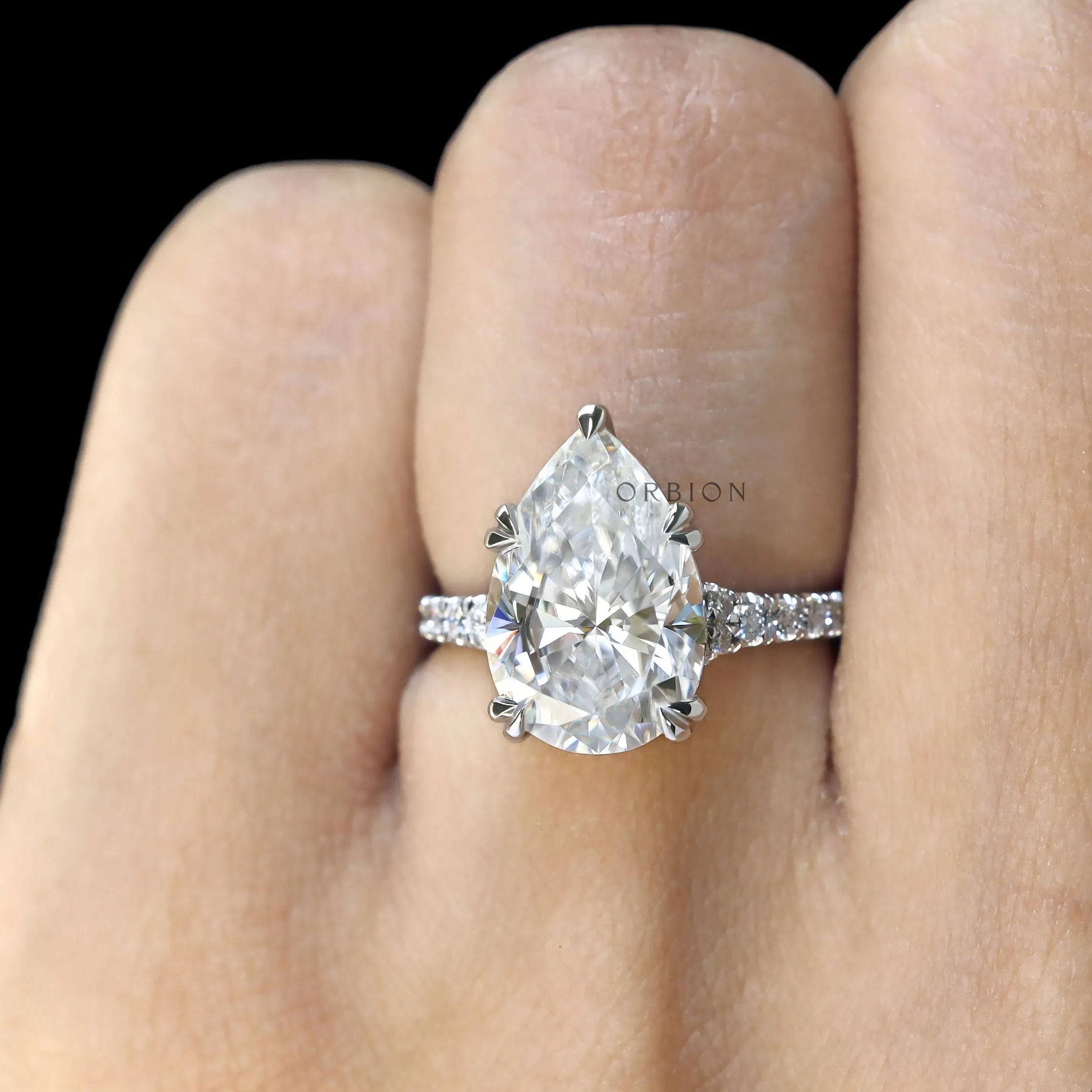 Handmade pear cut bridal ring in white gold with sparkling side stones