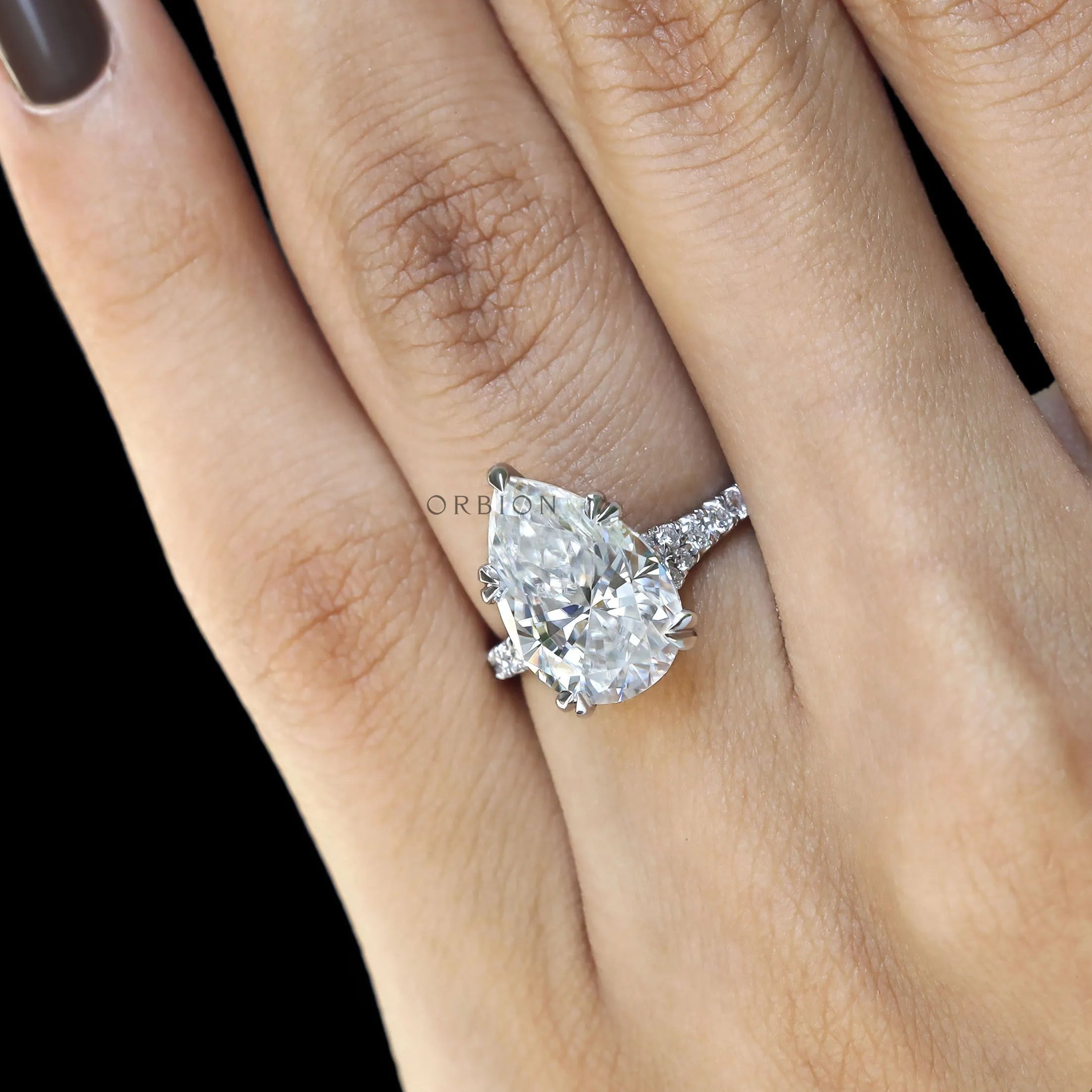 Statement pear engagement ring with cathedral setting and pave details