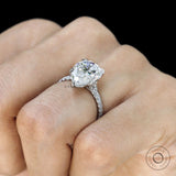 Pear solitaire ring with pave band and cathedral mount