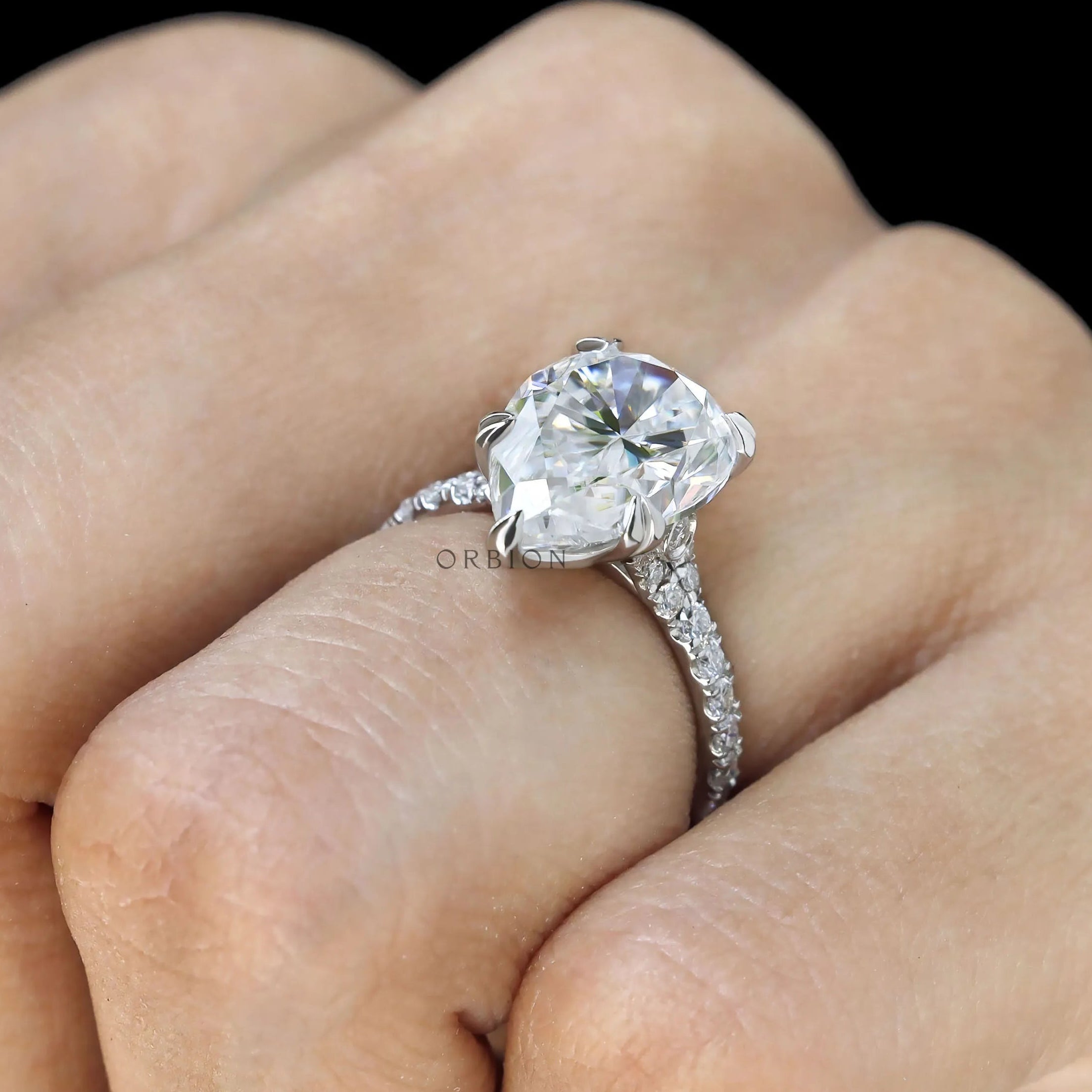 Pear solitaire ring with pave band and cathedral mount