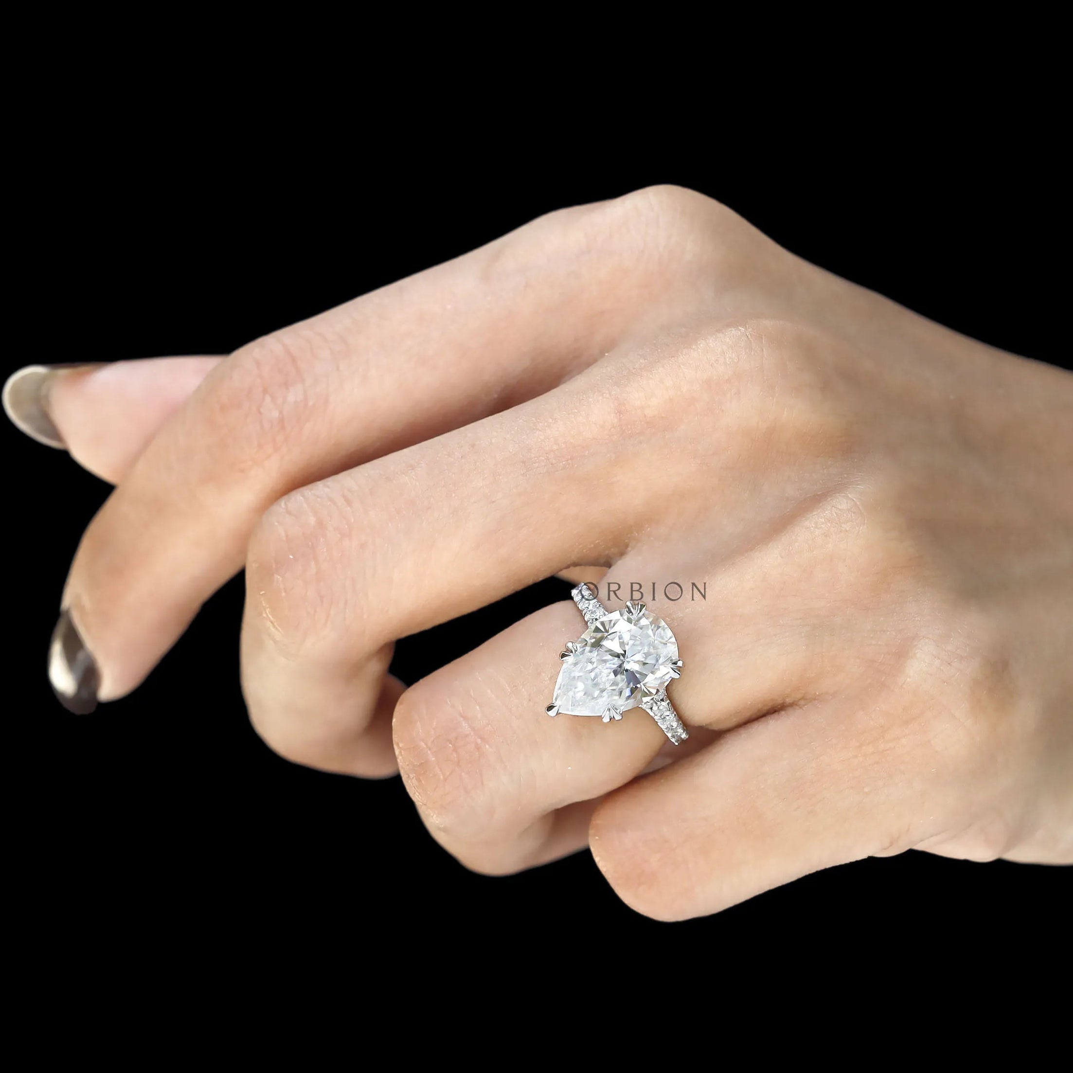 Large pear moissanite engagement ring with split shank cathedral setting