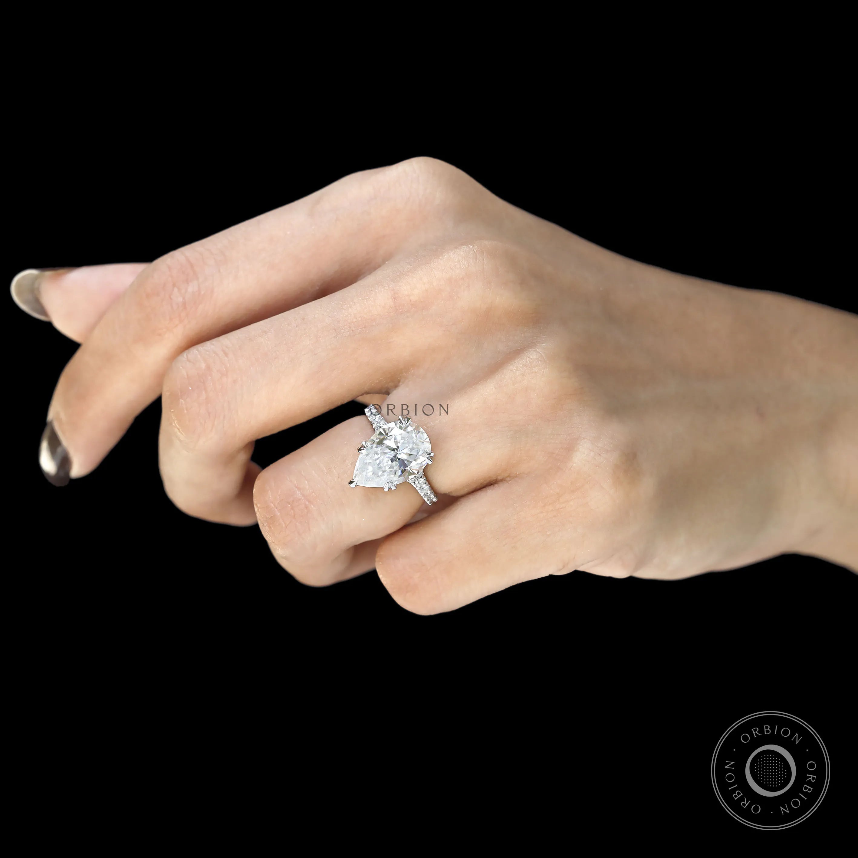 Large pear moissanite engagement ring with split shank cathedral setting