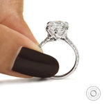Cathedral style pear engagement ring with sparkling pave accents