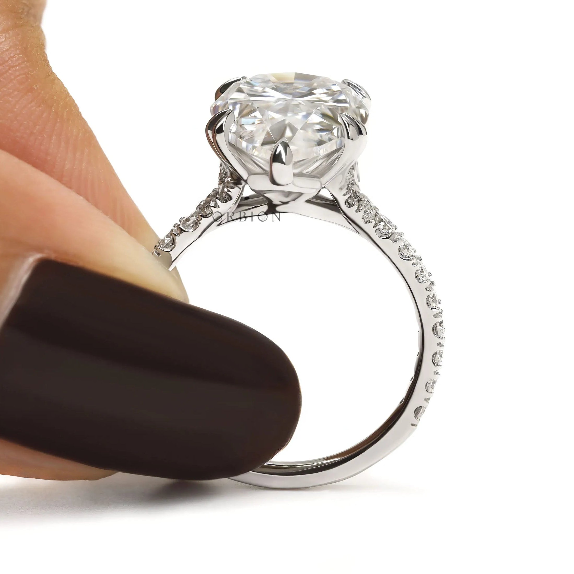 Cathedral style pear engagement ring with sparkling pave accents