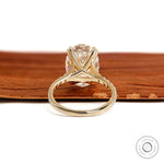 Big oval moissanite engagement ring in 10k yellow gold with pave split shank and lab diamond alternative