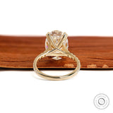 Big oval moissanite engagement ring in 10k yellow gold with pave split shank and lab diamond alternative