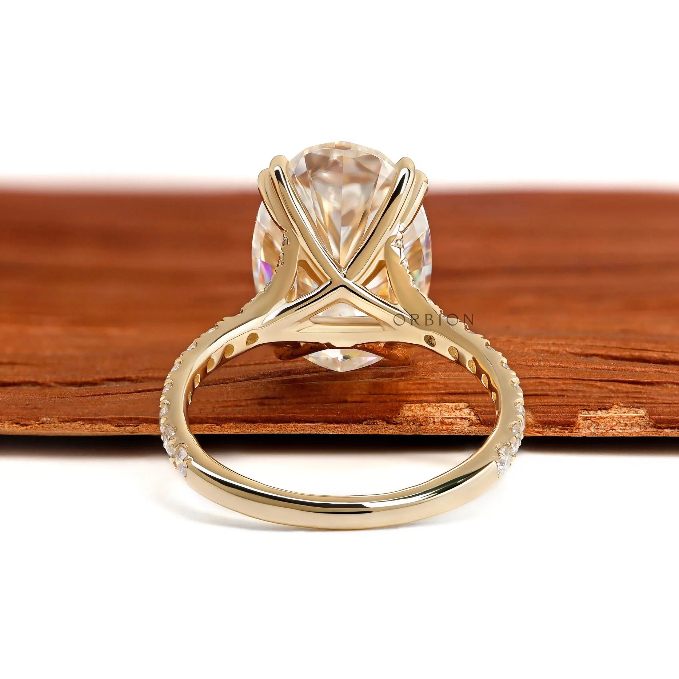 Big oval moissanite engagement ring in 10k yellow gold with pave split shank and lab diamond alternative
