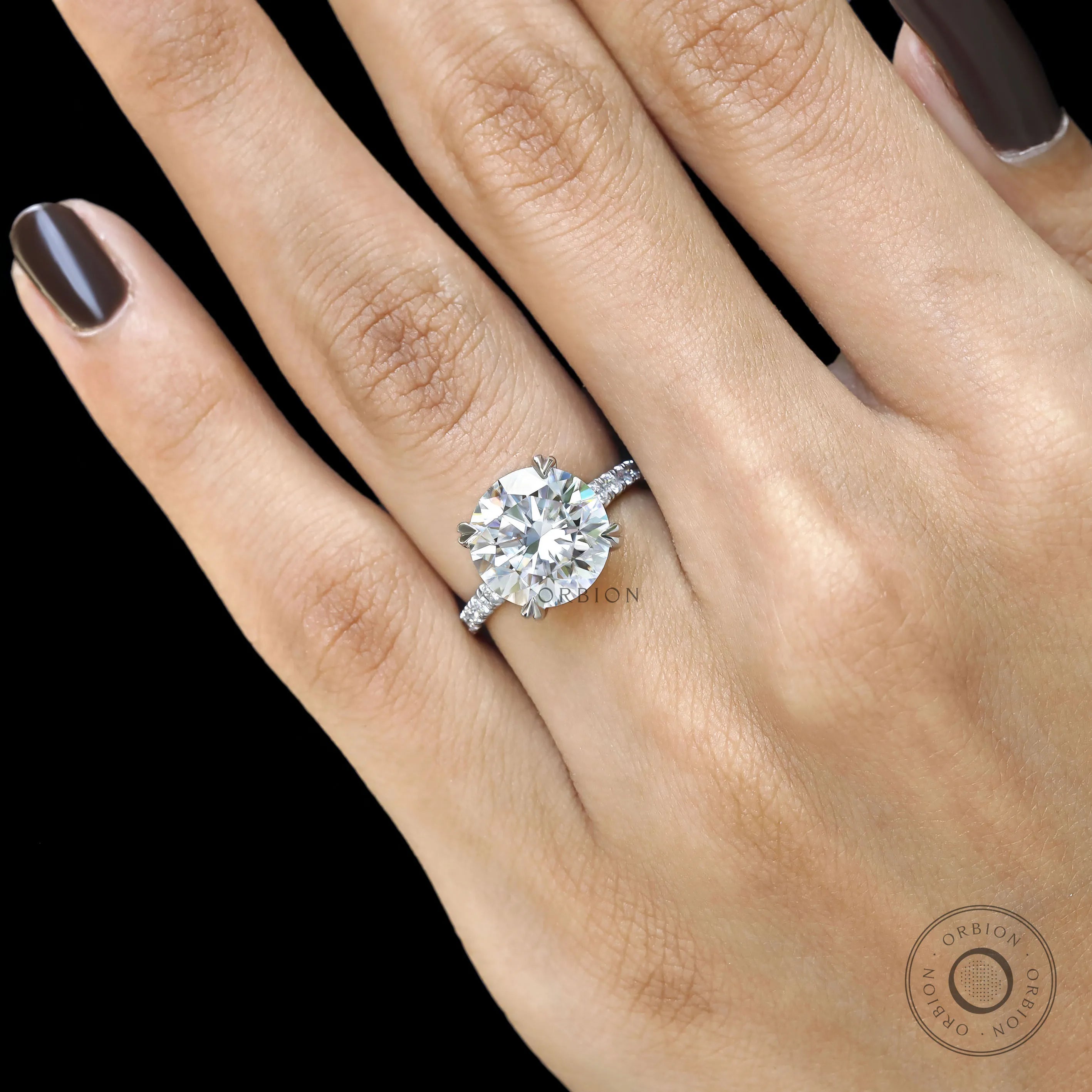 Elegant 10k white gold cathedral engagement ring with round moissanite and pave split shank