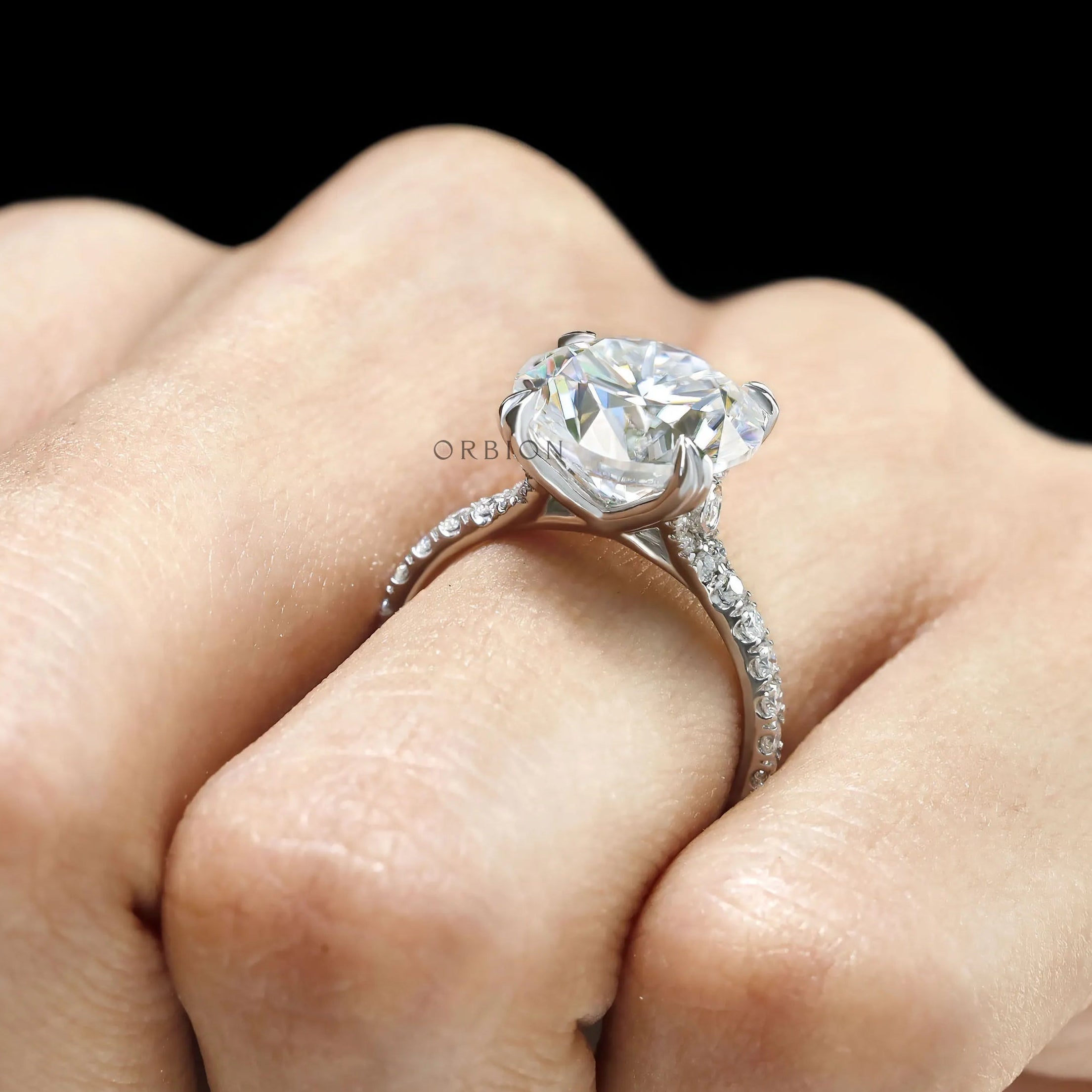 10k white gold cathedral ring with 10.5 MM round moissanite solitaire, pave set split shank
