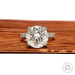Large round cut moissanite or lab diamond cathedral engagement ring, 10.5 MM solitaire, pave split shank, 10k white gold