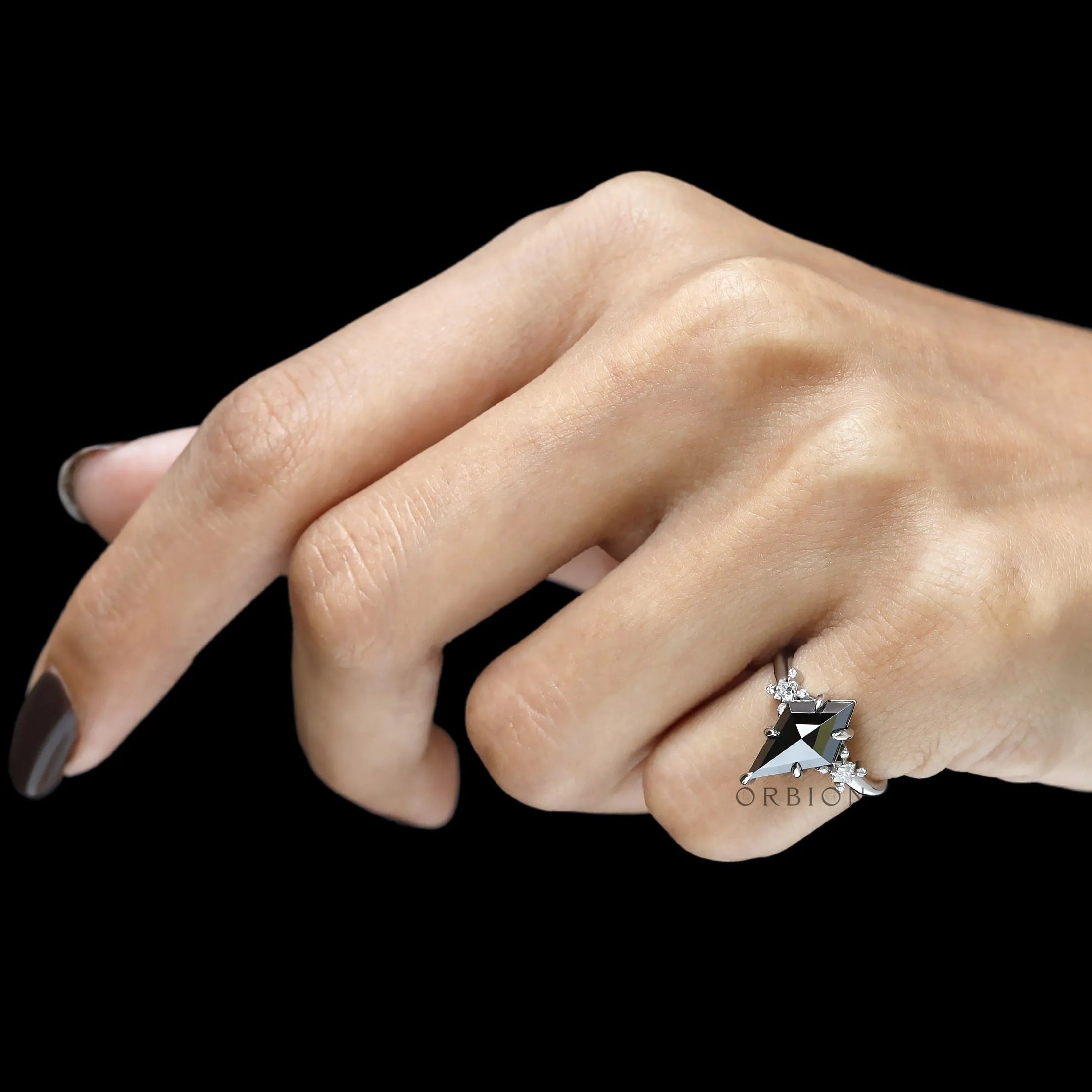 Platinum black moissanite ring with unique cluster design and mixed cut gemstone accents