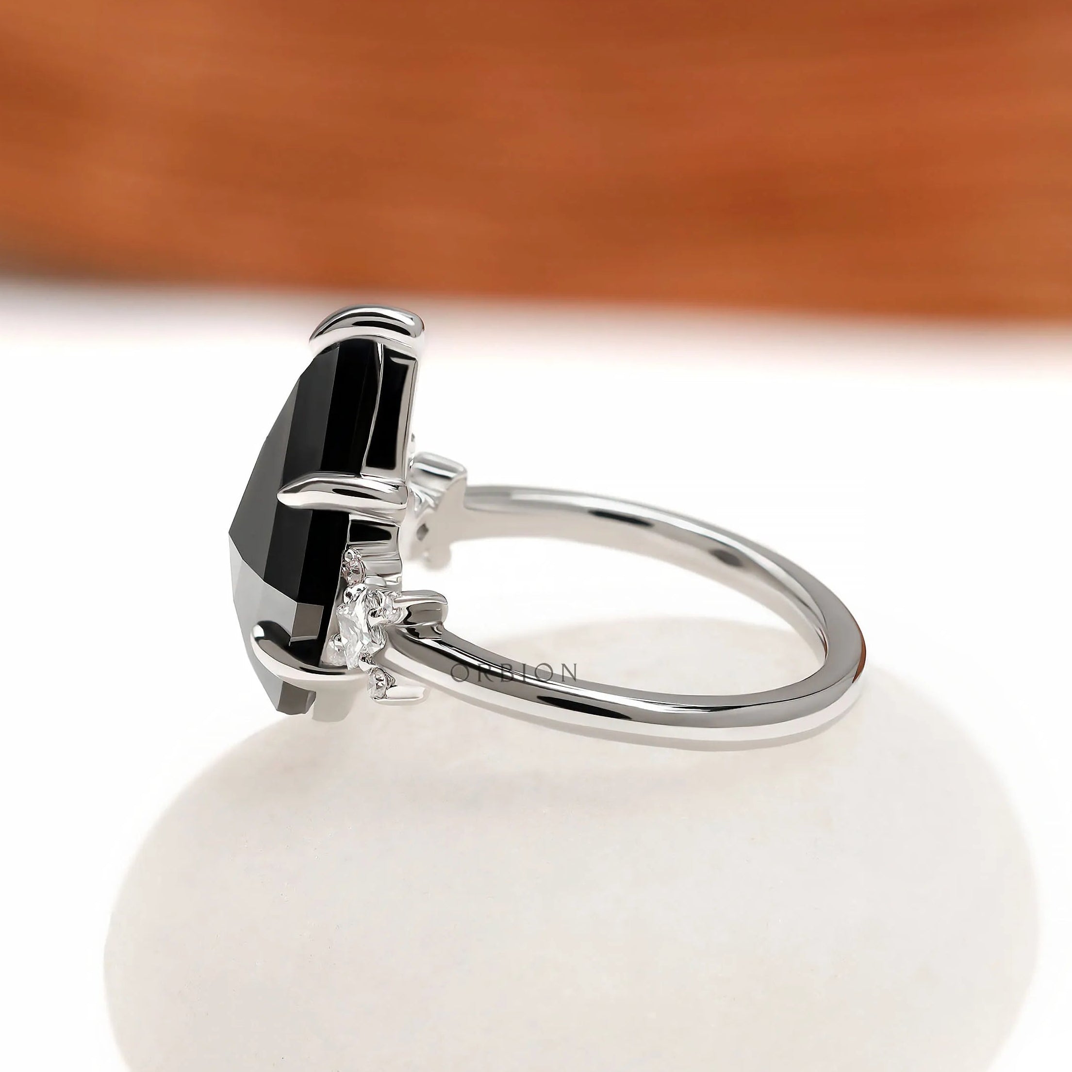 Platinum cluster engagement ring with kite cut black moissanite