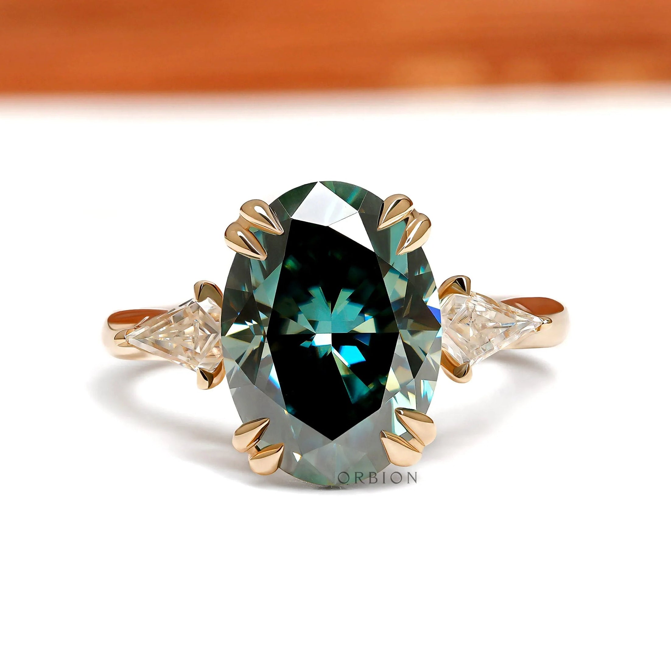 Oval blue green moissanite three stone cathedral engagement ring with kite accents 14k yellow gold 