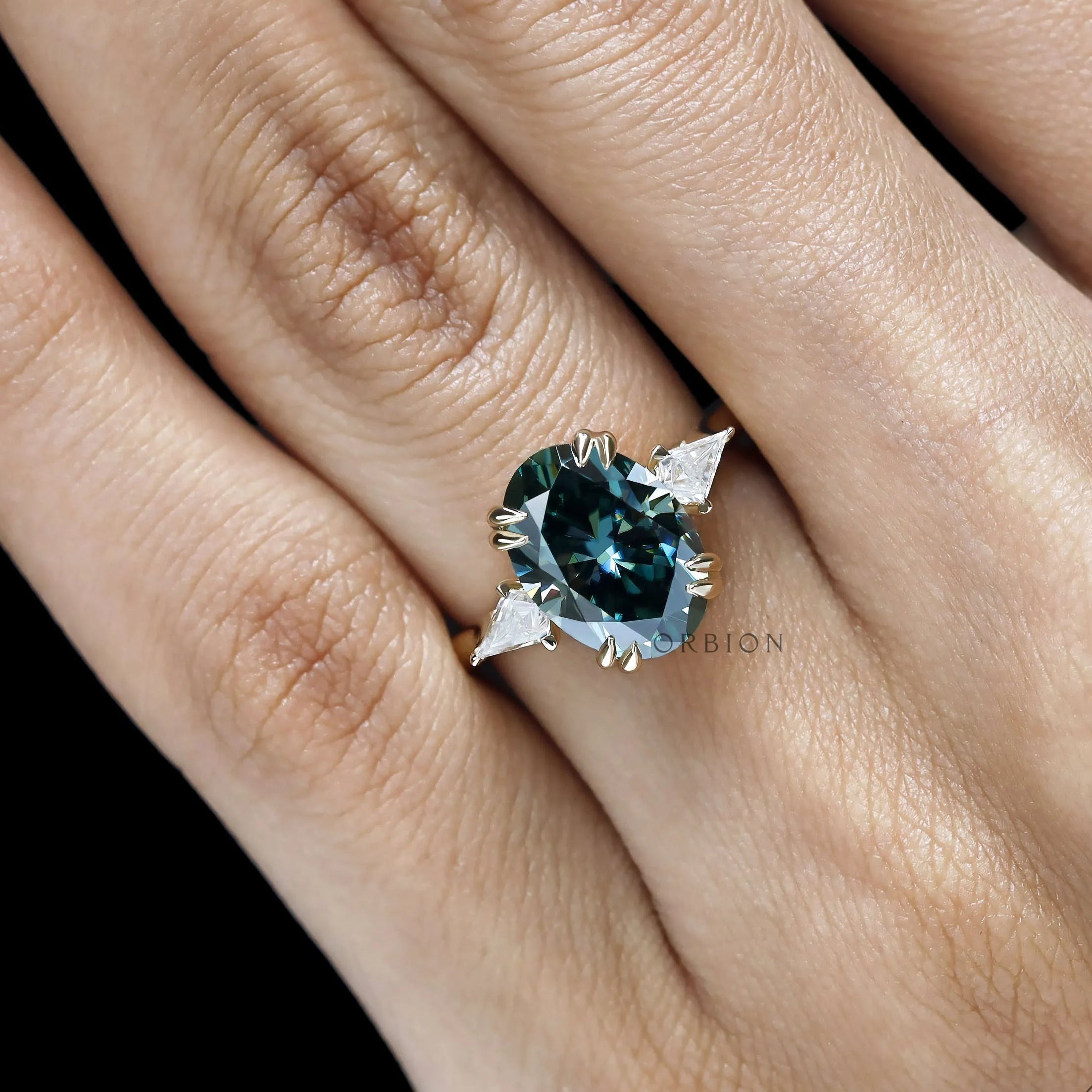 Color gemstone three stone bridal ring with floral bridge and high profile.