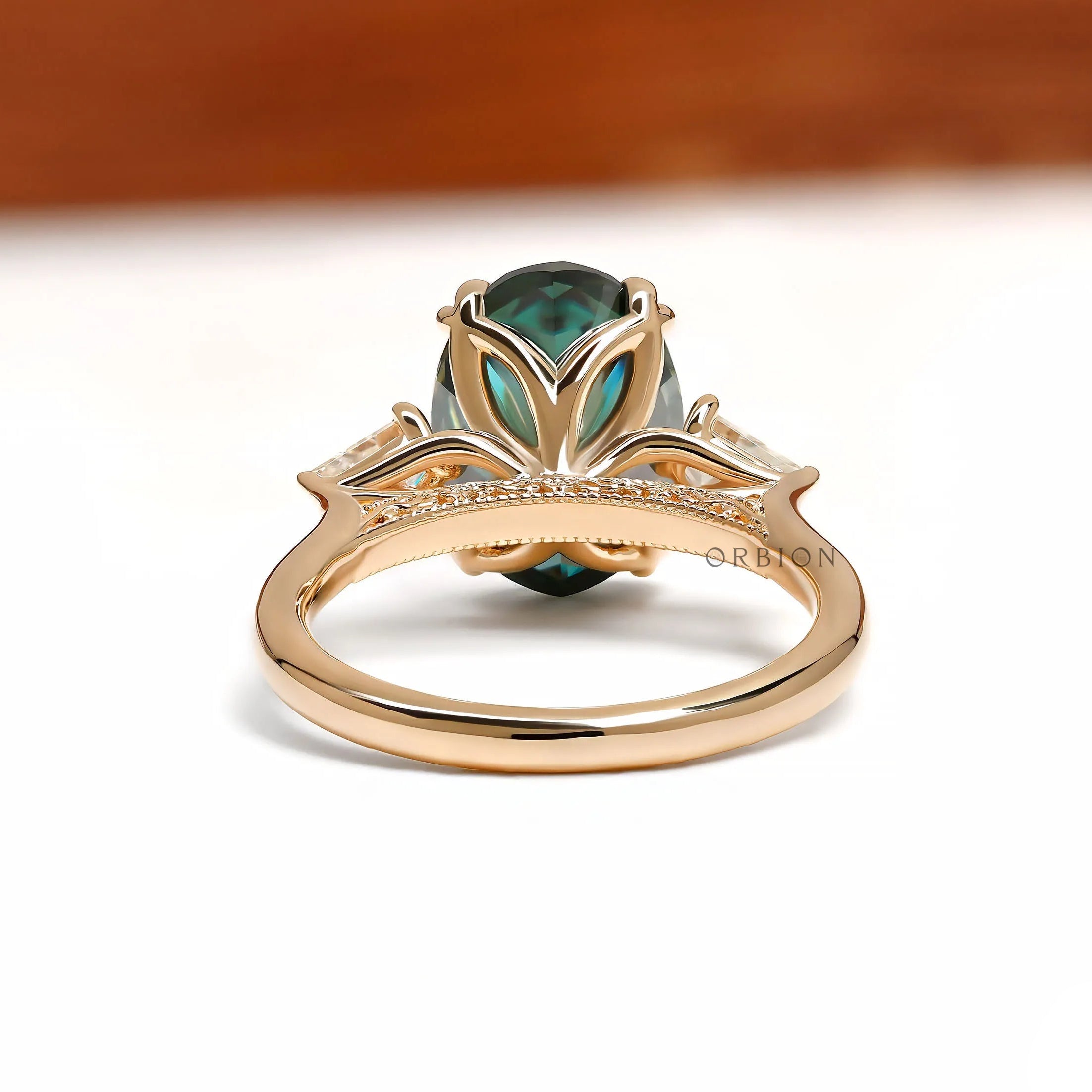 14k yellow gold engagement ring with oval blue green moissanite, trilogy cathedral design