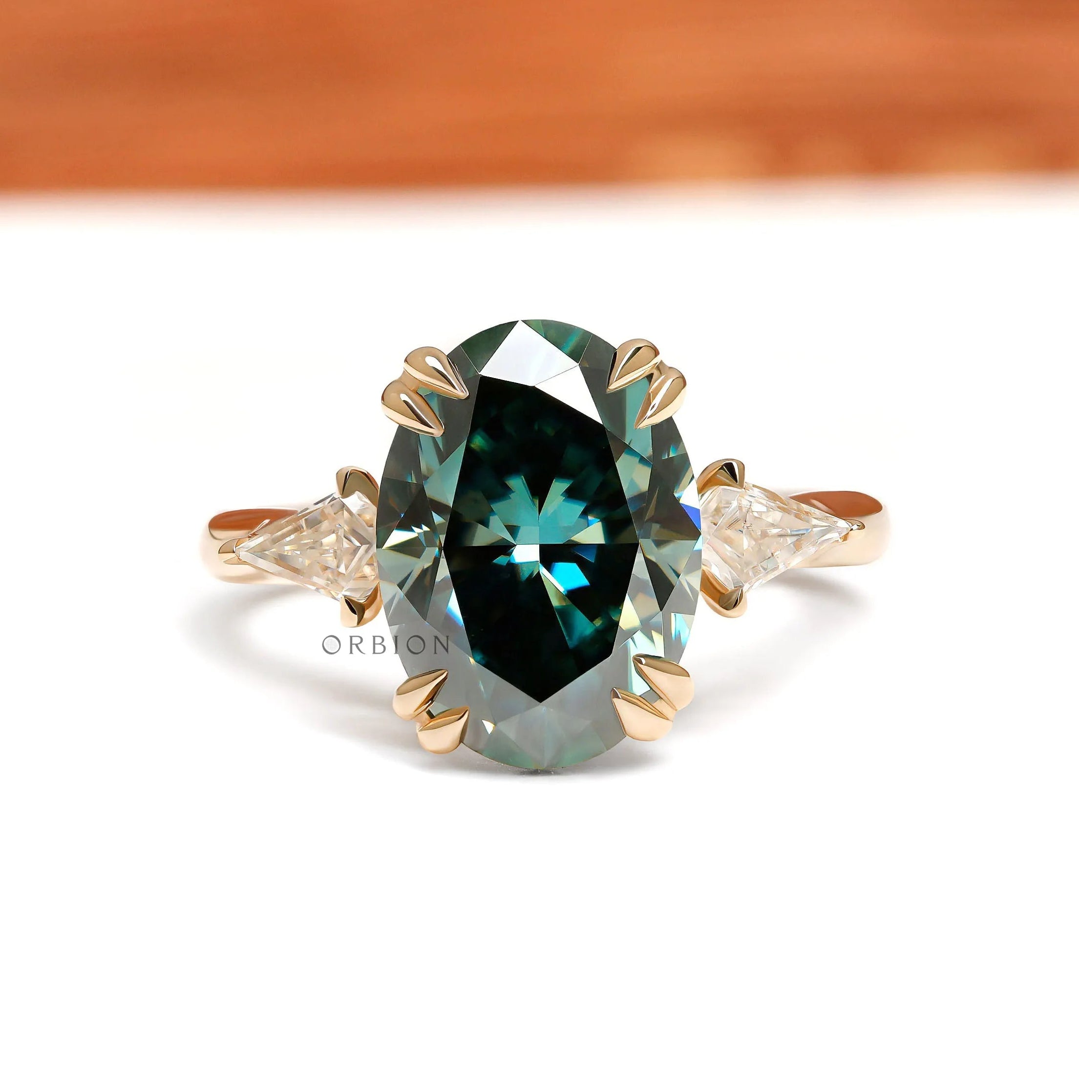 Oval blue green moissanite three stone cathedral engagement ring with kite accents 14k yellow gold 