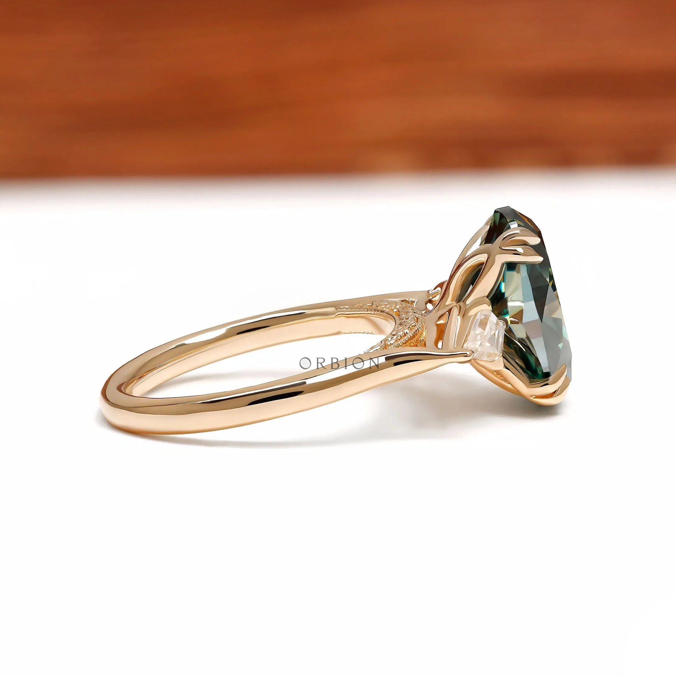 Three stone color stone ring with oval blue green moissanite, 14k yellow gold tulip setting and kite accents
